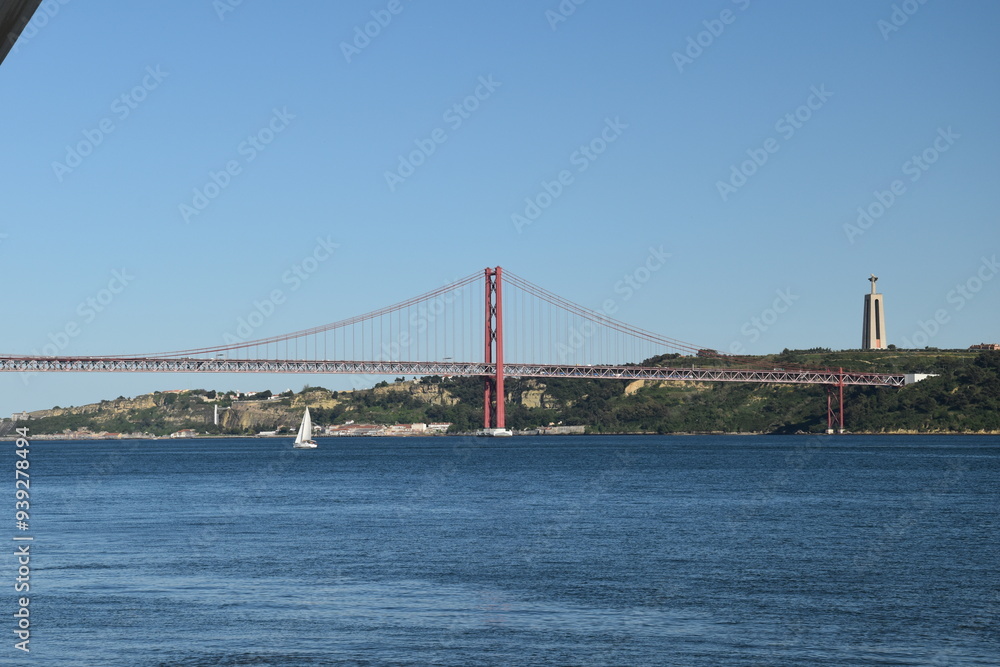 Fototapeta premium Suspension bridge crossing the river Tagus in Lisbon Portugal. The 25 de Abril Bridge. 