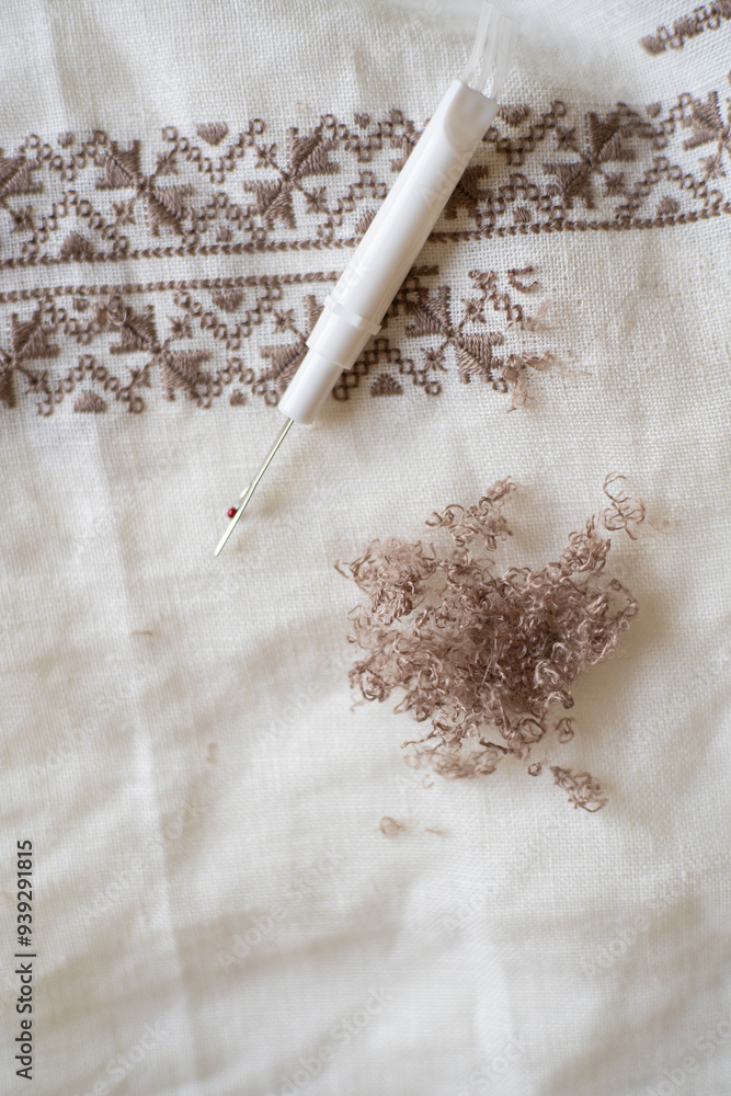 Fabric Ripper Embroidery process featuring a seam ripper and fabric with decorative ...