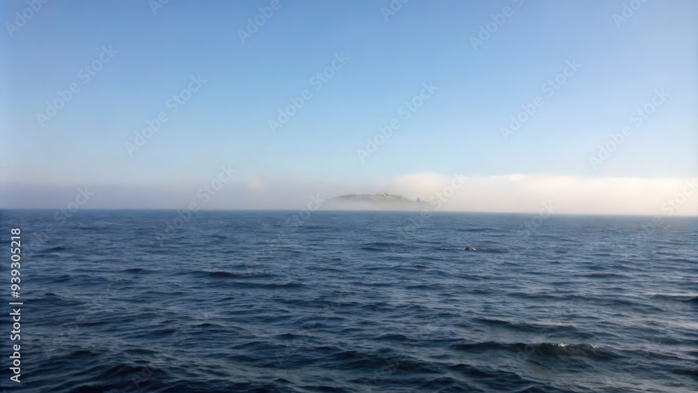 Fototapeta premium Island in the Mist on a Blue Ocean