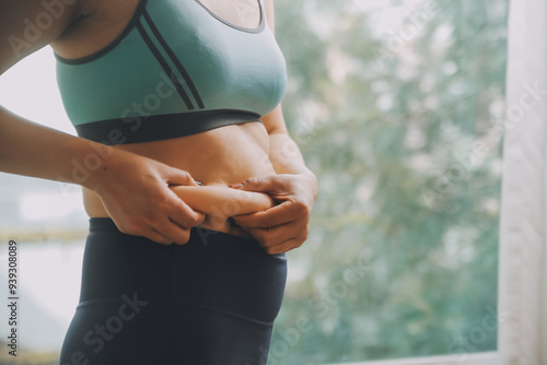 fat woman, fat belly, chubby, obese woman hand holding excessive belly fat with measure tape, woman diet lifestyle concept