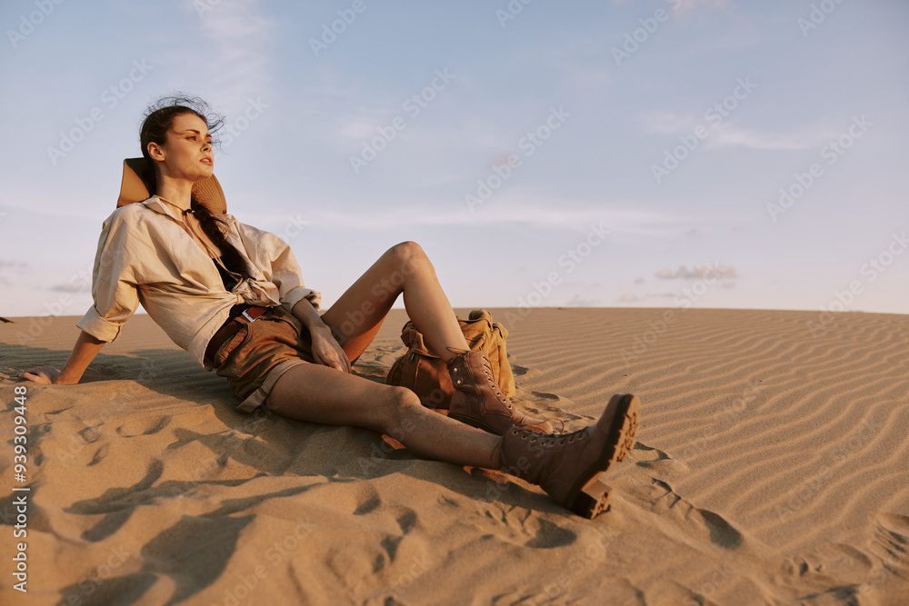 Woman Sitting on Sand Dune with Feet in the Air Enjoying Serene Desert Landscape View Woman Sitting on Sand Dune with Feet in the Air Enjoying Serene Desert Landscape View
