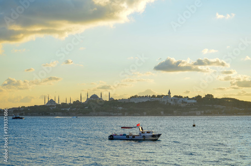 sunset and boat on the bosphorus, istanbul photo