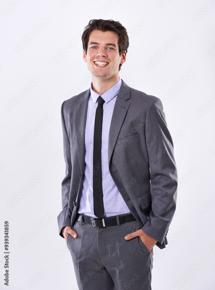 Fototapeta premium Business man, smile and hands in pocket for confidence, pride and professional on white background. Corporate lawyer, portrait and cool in studio with suit, success and happiness for career ambition