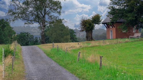 Country Path Between Fields with a Small Hidden Chapel in the Background