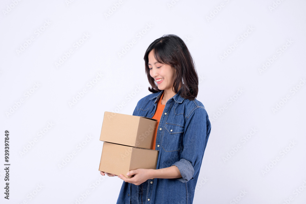 Happy woman holding two cardboard boxes, smiling with joy. Happy woman holding two cardboard boxes, smiling with joy.
