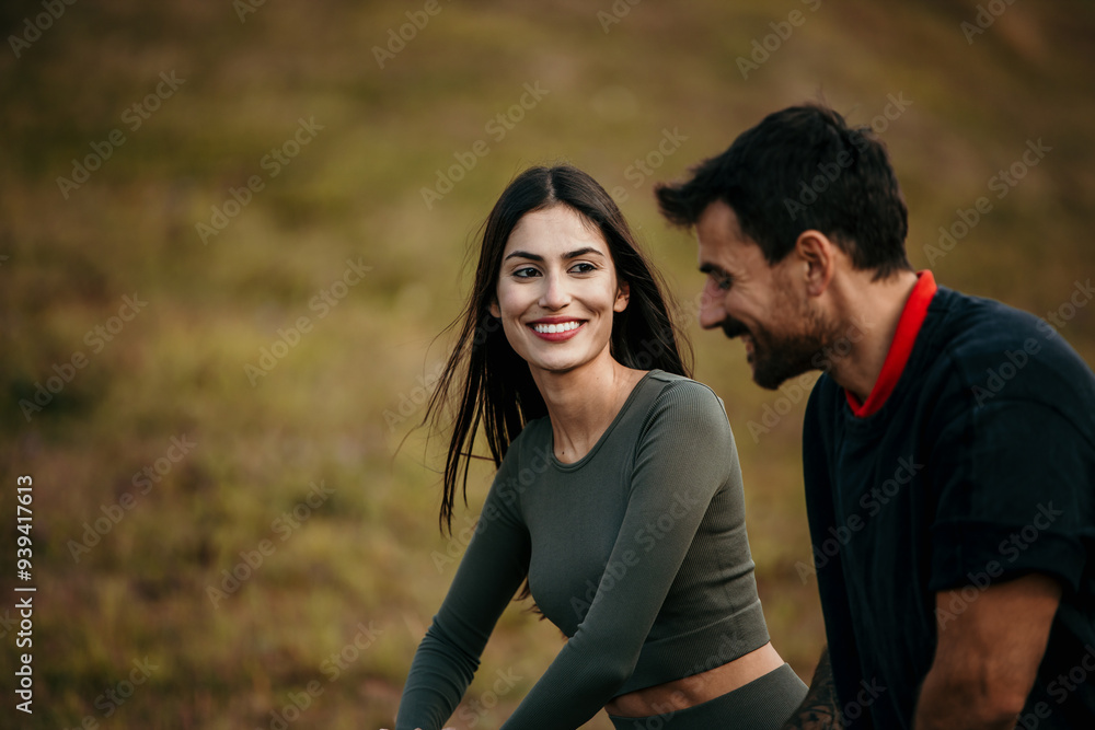 A young couple doing warm-up exercises on a sunny day A young couple doing warm-up exercises on a sunny day