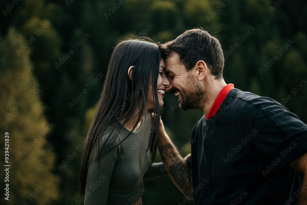 A young man and woman in sportswear talking and laughing while running together in a park A young man and woman in sportswear talking and laughing while running together in a park