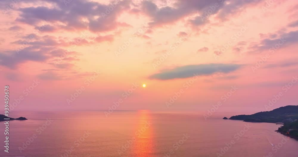 Aerial panorama view of the beautiful sunset above the Patong Gulf during the evening. the turquoise ocean water of a tropical island meeting the sandy beach with boats moored near the shore. Aerial panorama view of the beautiful sunset above the Patong Gulf during the evening. the turquoise ocean water of a tropical island meeting the sandy beach with boats moored near the shore.
