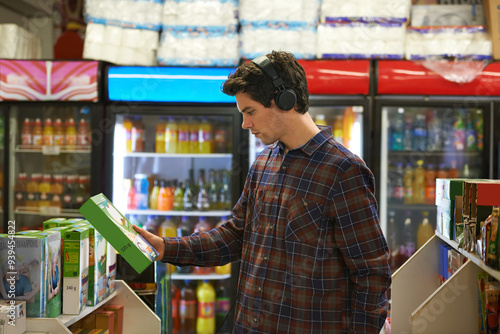 Quadro su tela Man, cereal and shopping in shop for grocery, food and decision with headphones, music and streaming