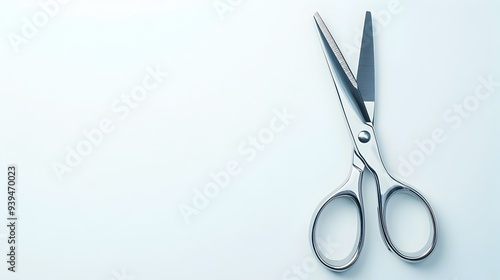 A photograph showcasing a pair of sharp stainless steel scissors with clean elegant design isolated on a plain white background