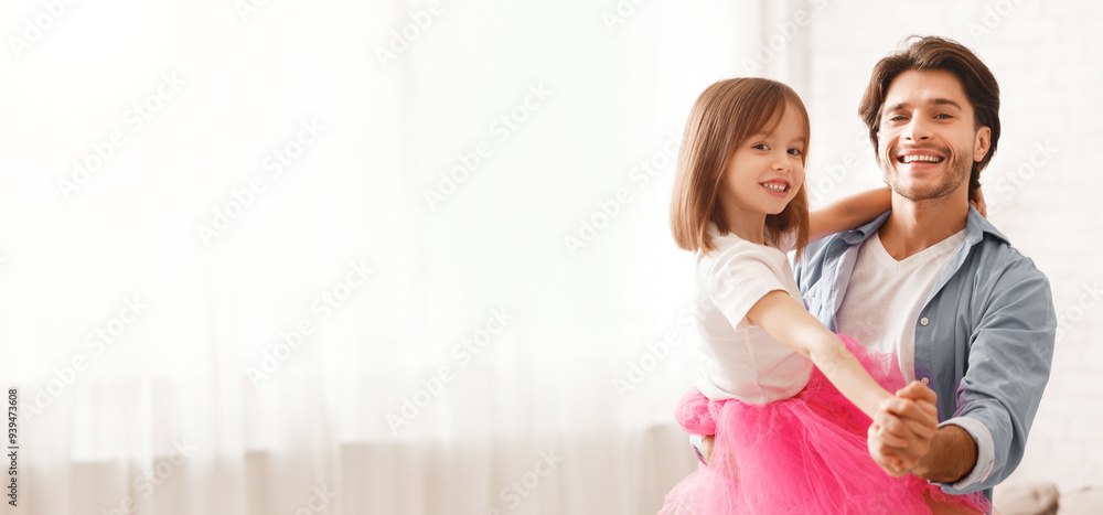 Joyful father and little daughter dancing waltz at home, dad holding girl Joyful father and little daughter dancing waltz at home, dad holding girl