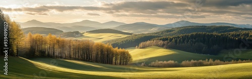 Serene winter landscape with rolling hills and distant mountains at sunset