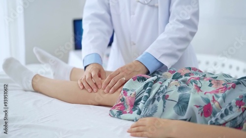 Doctor and kid patient. Orthopedist examining girl's knee in medical clinic. Medicine and health care photo