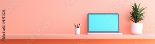 A modern workspace featuring a laptop, desk plant, and stationery, set against a vibrant peach wall for a fresh and creative feel.