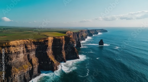 The iconic cliffs of Moher towering over the Atlantic Ocean, Ireland, with waves crashing below