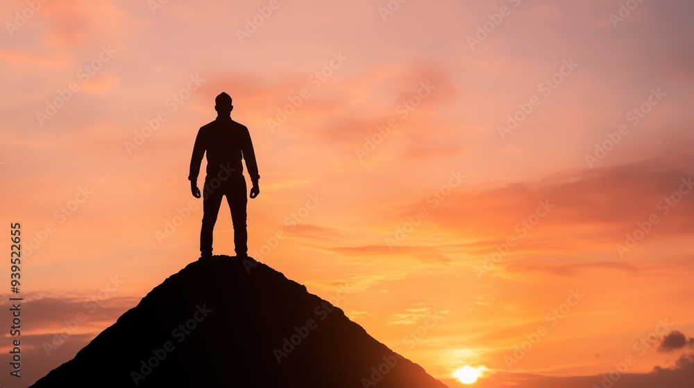 A silhouetted figure stands atop a hill against a stunning sunset, representing achievement, freedom, and contemplation. A silhouetted figure stands atop a hill against a stunning sunset, representing achievement, freedom, and contemplation.