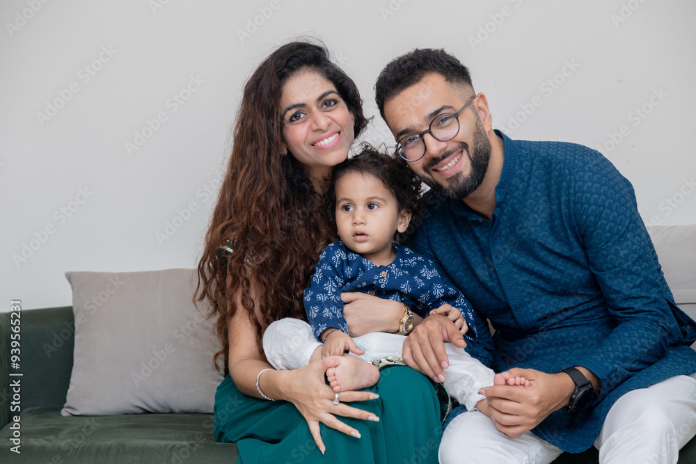 Portrait of Indian couple in Traditional wear sitting on sofa Portrait of Indian couple in Traditional wear sitting on sofa