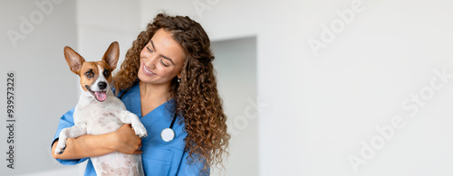 Bild auf Leinwand Woman vet in blue uniform smiling as she holds small white and brown dog, provid