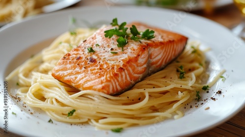 Plate of pasta with piece of salmon background horizontal composition