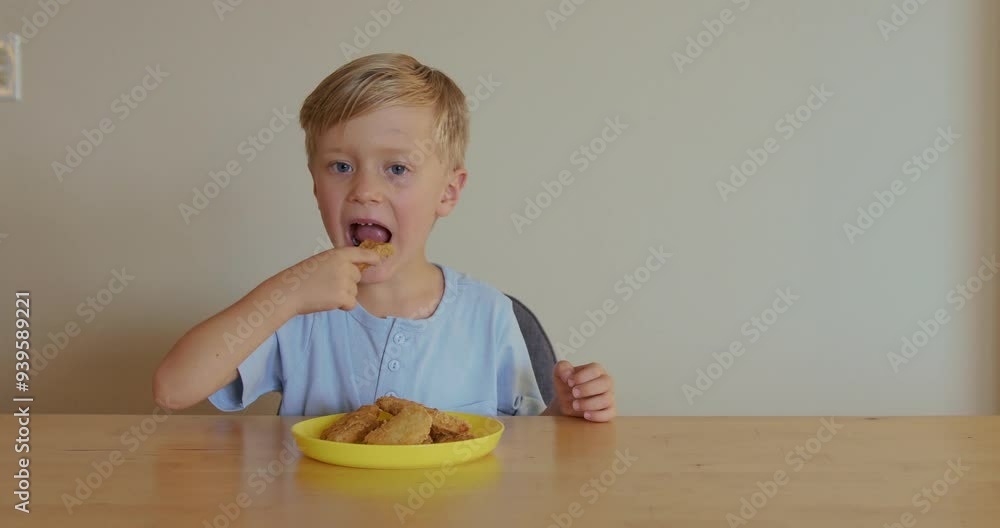 Happy child eating fast food at home chicken nuggets. Boy eats food at home. Happy child eating fast food at home chicken nuggets. Boy eats food at home.