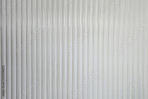 Close-Up of Corrugated Glass Texture with Reflections in Modern Living Room Decor - Vertical Wave Pattern