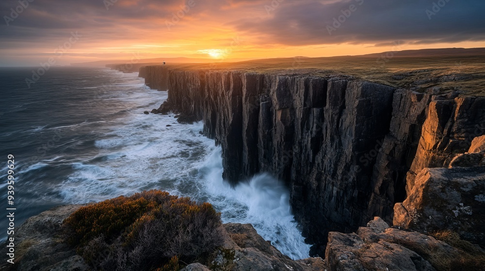 A view of a cliff at sunset, showing the stark beauty of a seascape. The scene shows towering cliffs with jagged edges overlooking a stormy ocean A view of a cliff at sunset, showing the stark beauty of a seascape. The scene shows towering cliffs with jagged edges overlooking a stormy ocean