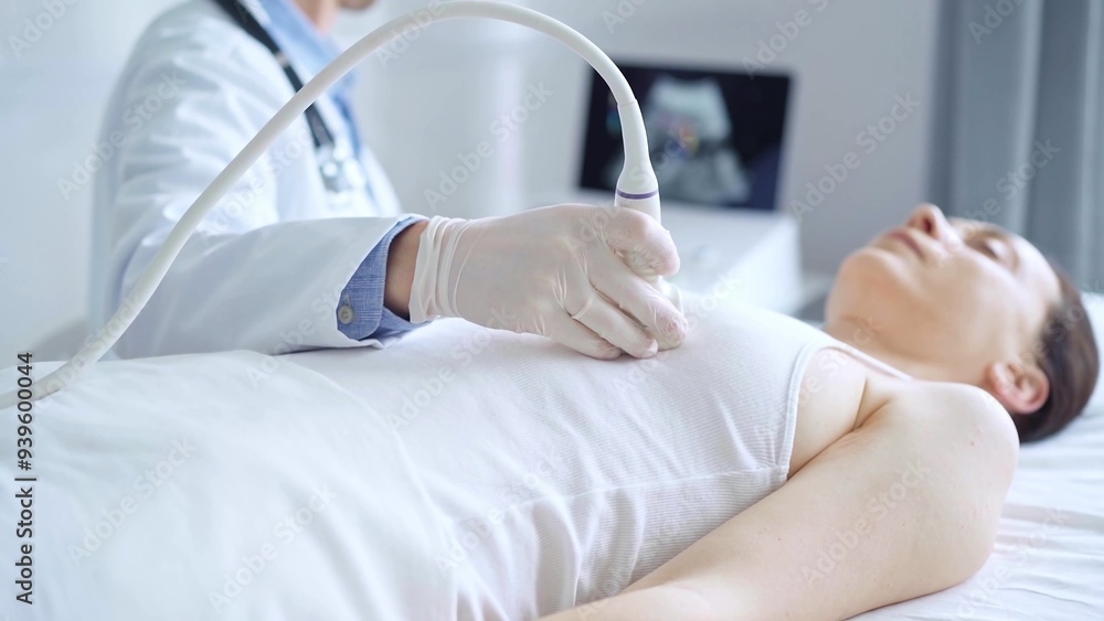 Fototapeta premium Doctor man using ultrasound equipment on the breast of a female patient. Female breast cancer prevention. mammary gland health. Medicine concept