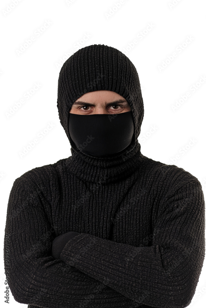 A figure dressed entirely in black attire, including a balaclava and turtleneck, stands with arms crossed on a transparent background, evoking feelings of mystery. Transparent background PNG A figure dressed entirely in black attire, including a balaclava and turtleneck, stands with arms crossed on a transparent background, evoking feelings of mystery. Transparent background PNG