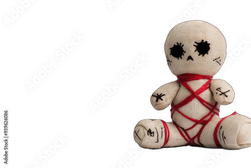 A spooky voodoo doll with a stitched face and red yarn tied around its body, perfect for Halloween or thematic decorations. photo