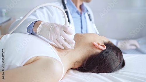 Doctor man is using ultrasound equipment on neck of female patient lying down for a medical examination. Medicine and science