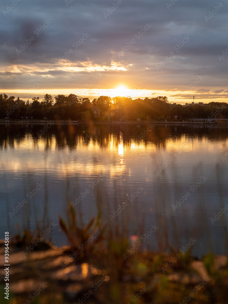 Obraz premium warm summer sunset over pond in Kaliningrad city