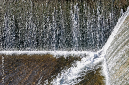 Water flowing from overflowing dam