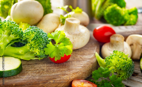 Fresh organic vegetables on a wooden table, close-up. Healthy cooking background for meal preparation or vegan recipes