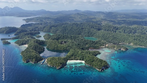 Aerial view of an island with empty beautiful beaches, blue ocean water, corals and a lake. Karina Beach, Jellyfish Lake. Togean National Park, Paradise Island, Central Sulawesi, Indonesia