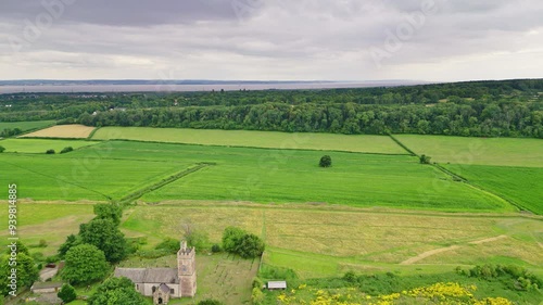 Aerial view of a medieval church and green fields photo