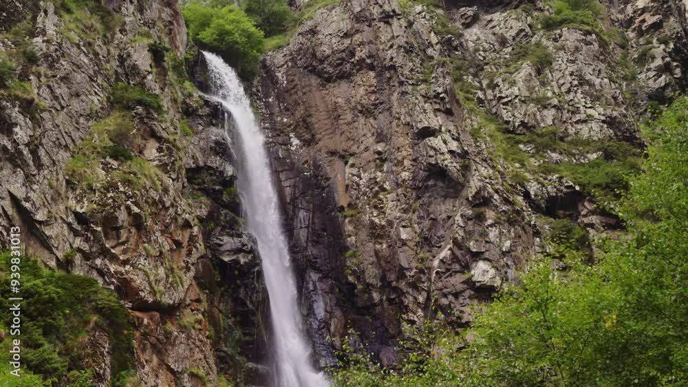 Large waterfall is located among plants and trees. A stream of clear water flows down from a cliff. Caucasus Mountains, Georgia, Gvelet waterfall. Slow motion Large waterfall is located among plants and trees. A stream of clear water flows down from a cliff. Caucasus Mountains, Georgia, Gvelet waterfall. Slow motion