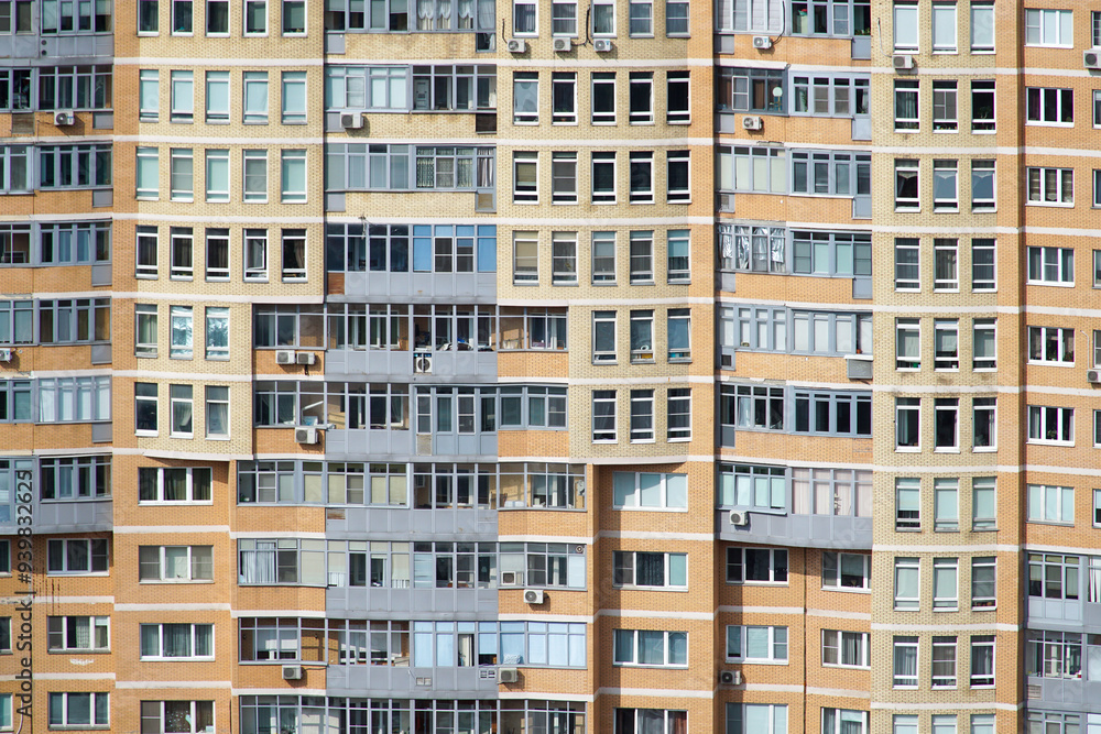 Facade of a multi-storey residential building. Residential multi-apartment building. Facade of a multi-storey residential building. Residential multi-apartment building.