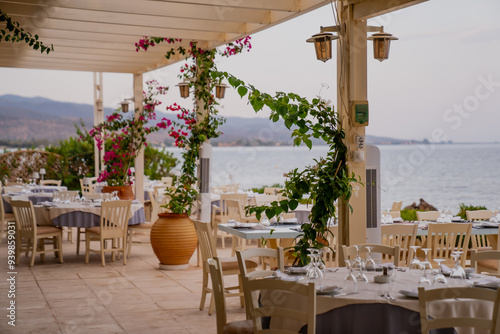 Fototapeta Naklejka Na Ścianę i Meble -  Fantastic dinner restaurant next to a brach in coast of the sea in Greece