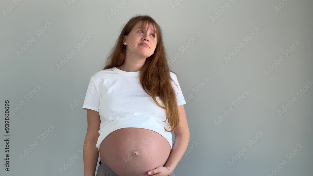 Sad frustrated pregnant woman isolated on grey background Sad frustrated pregnant woman isolated on grey background