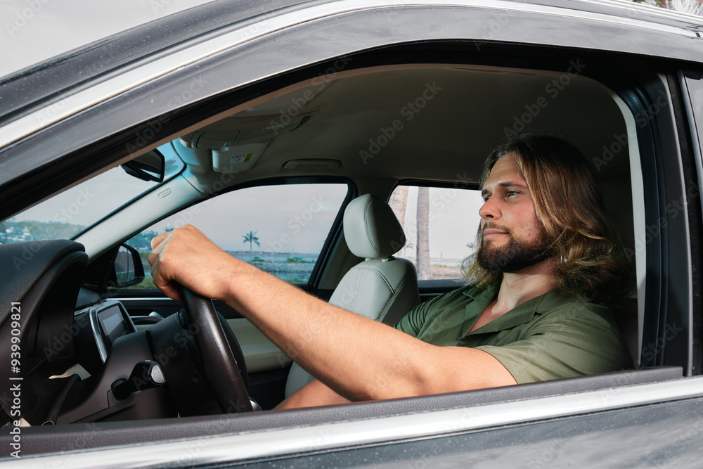 Man driving a car with a serene seaside background Man driving a car with a serene seaside background