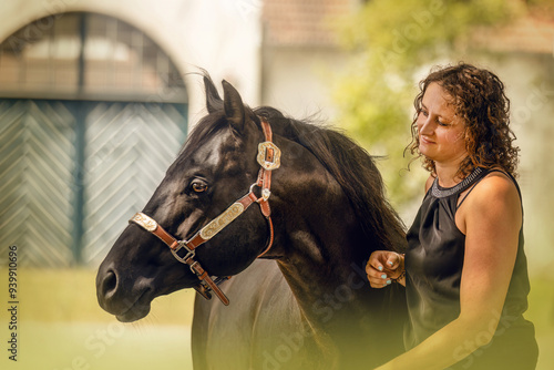 Equestrian lifestyle: A woman and her quarter horse stallion interacting together in summer outdoors