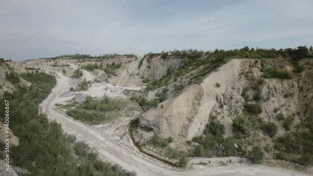 This breathtaking aerial video takes you on a journey above a vast limestone quarry, revealing its intricate details and rugged beauty. The sheer scale of the quarry is evident as the camera pans This breathtaking aerial video takes you on a journey above a vast limestone quarry, revealing its intricate details and rugged beauty. The sheer scale of the quarry is evident as the camera pans
