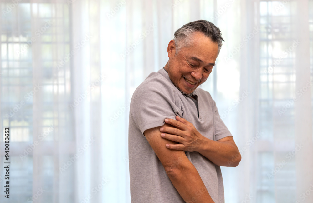 Senior asian man experiencing itchiness on his arm, scratching his upper arm with a concerned expression, skin irritation and itchiness in older adults, senior health, skin care and medical attention Senior asian man experiencing itchiness on his arm, scratching his upper arm with a concerned expression, skin irritation and itchiness in older adults, senior health, skin care and medical attention