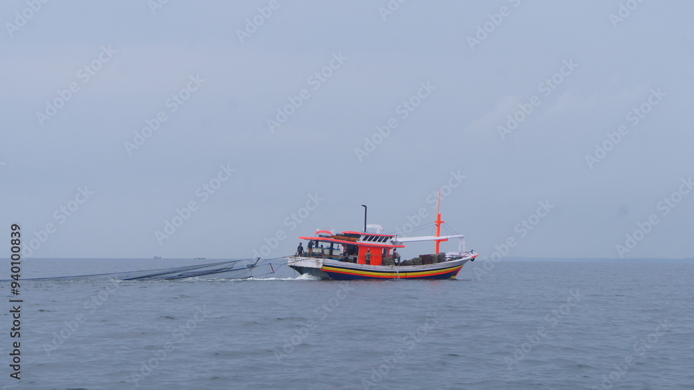 Traditional Fishing Boat Sailing on Calm Sea Traditional Fishing Boat Sailing on Calm Sea