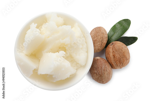Natural shea butter in bowl, nuts and green leaves isolated on white, top view