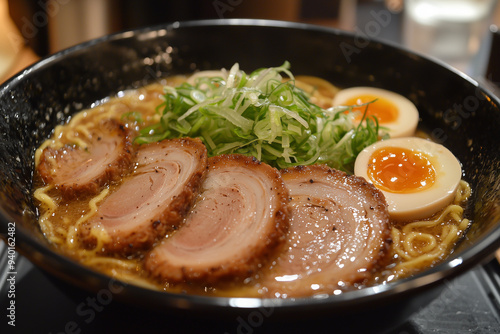 Ramen noodle soup in bowl on table.