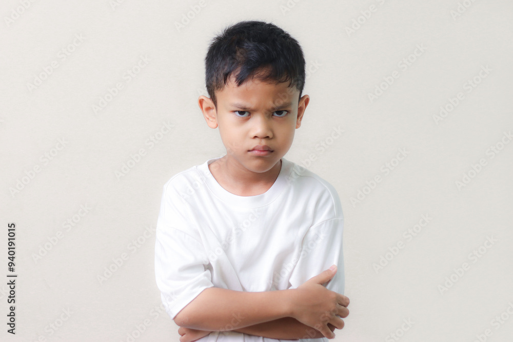 Angry little asian boy wearing white shirt showing frustration and disagreement. Angry little asian boy wearing white shirt showing frustration and disagreement.