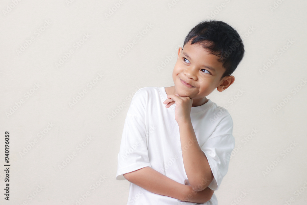Thinking a cute little asian boy on white background. Child thinking. Education concept. Brainstorming and idea concept. Thinking a cute little asian boy on white background. Child thinking. Education concept. Brainstorming and idea concept.
