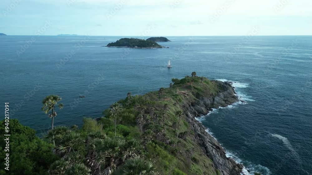Aerial view yacht anchored along the shore in Promthep Cape, Phuket Islands,Thailand. 4K drone footage video Aerial view yacht anchored along the shore in Promthep Cape, Phuket Islands,Thailand. 4K drone footage video
