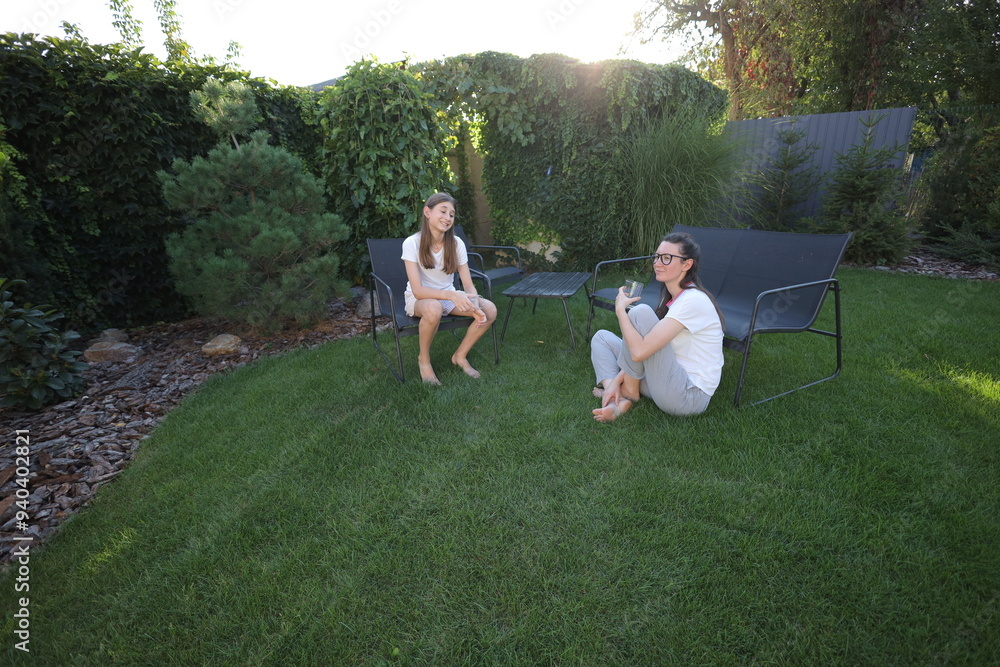Mother and daughter talking in the backyard Mother and daughter talking in the backyard